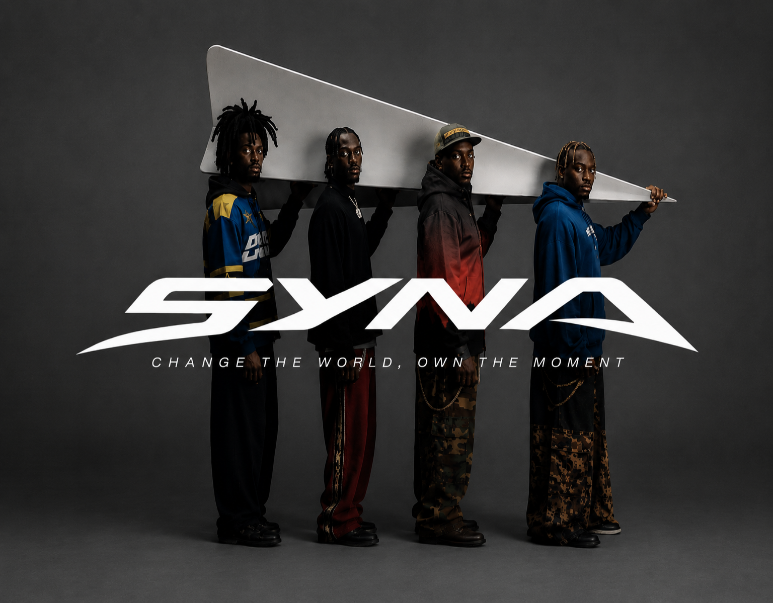 Four individuals holding a large white paddle against a dark background with 'SYNA' branding.